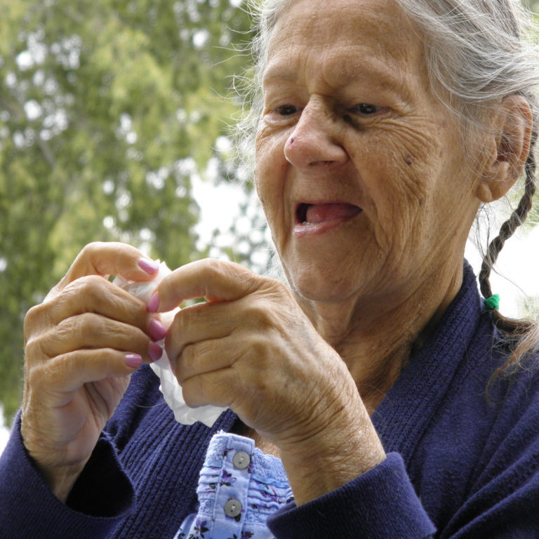 Elderly woman at park talking